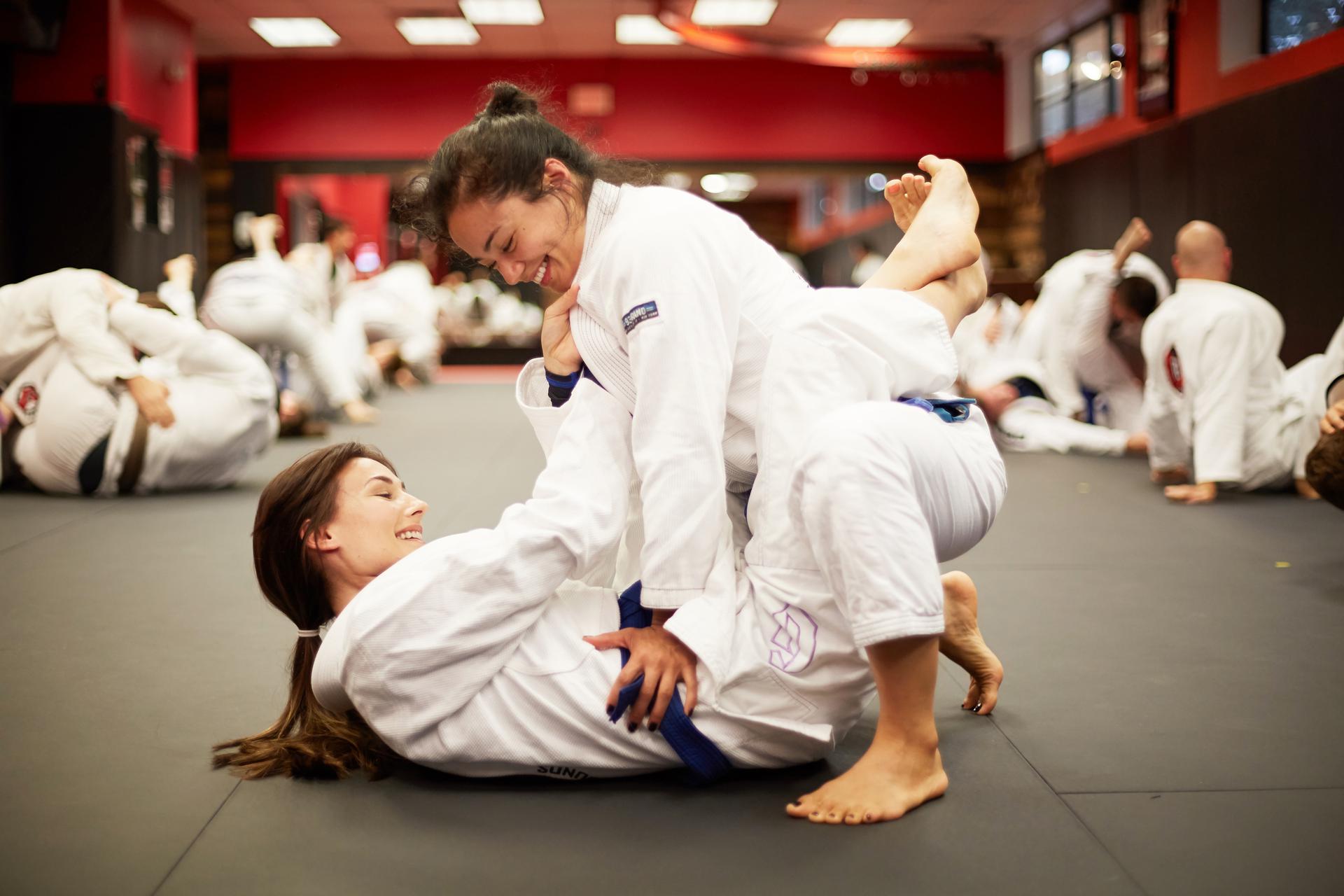 two girls training martial arts in westwood nj and smiling