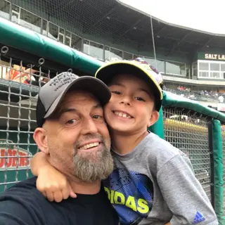 father and son who train smiling after the adults and kids martial arts classes